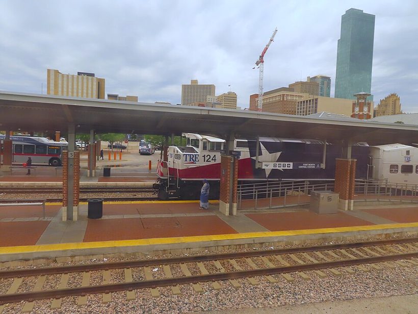 A Trinity Railway Express (TRE) train at the station, the train fans ride toward the stadium
